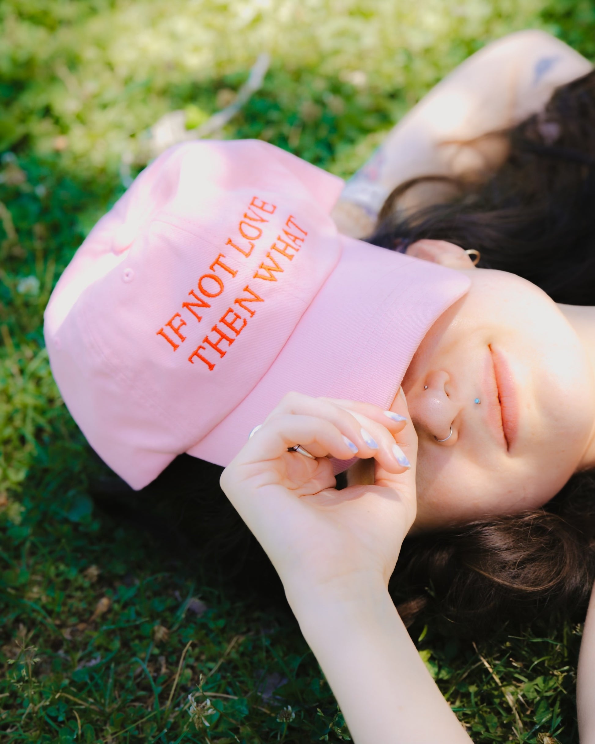 Pink dad hat featuring red embroidered text that reads "IF NOT LOVE THEN WHAT"